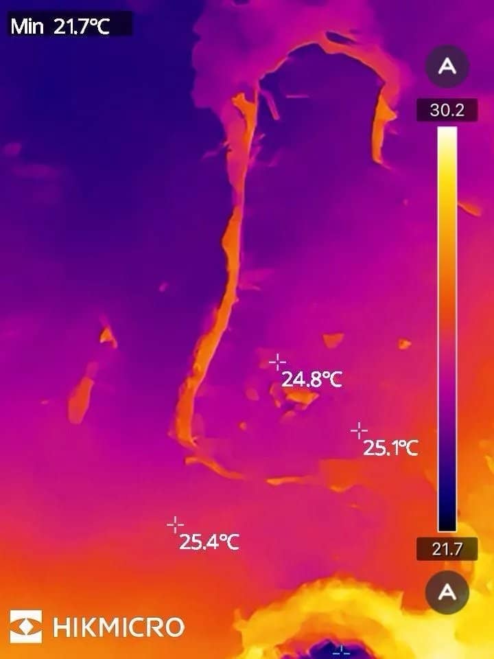 Thermal imaging camera showing a cooler damp patch tracking across an internal ceiling