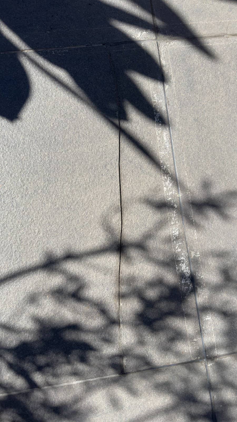 Cracked tile being inspected before repair.