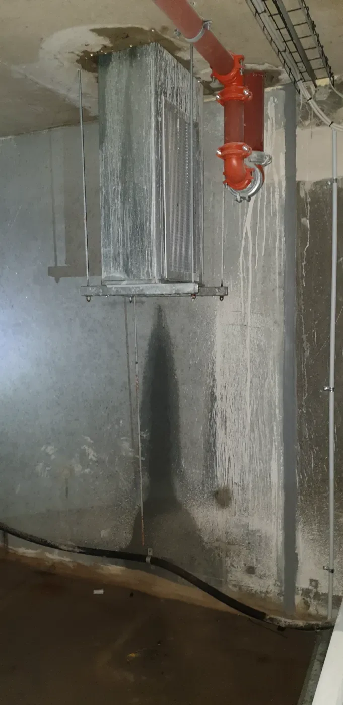 Water tracking down a basement column and pooling on the slab