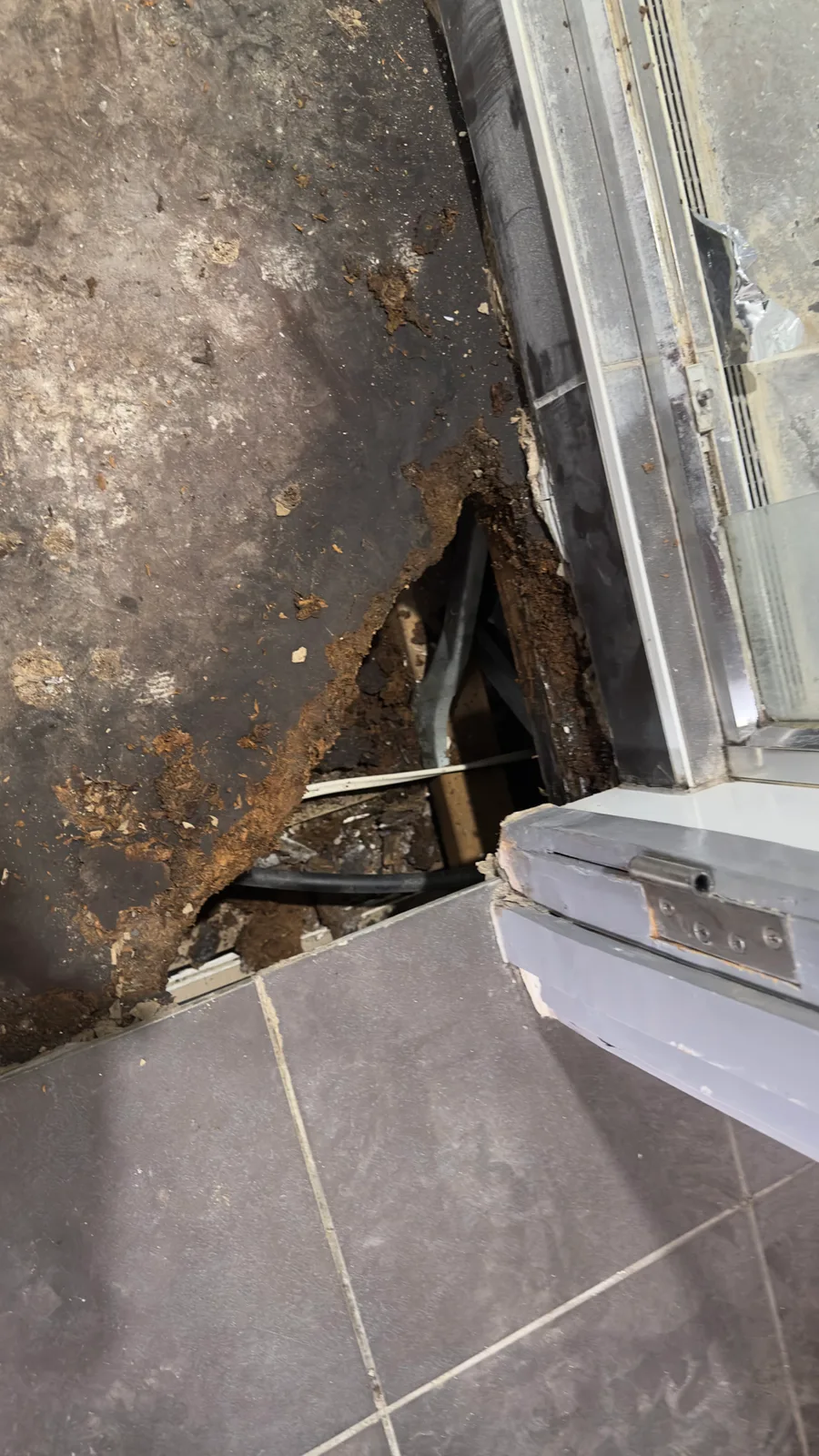 Damage found beneath the bathroom floor tiling